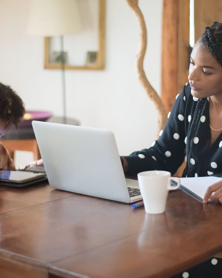 A working mother at her kitchen table